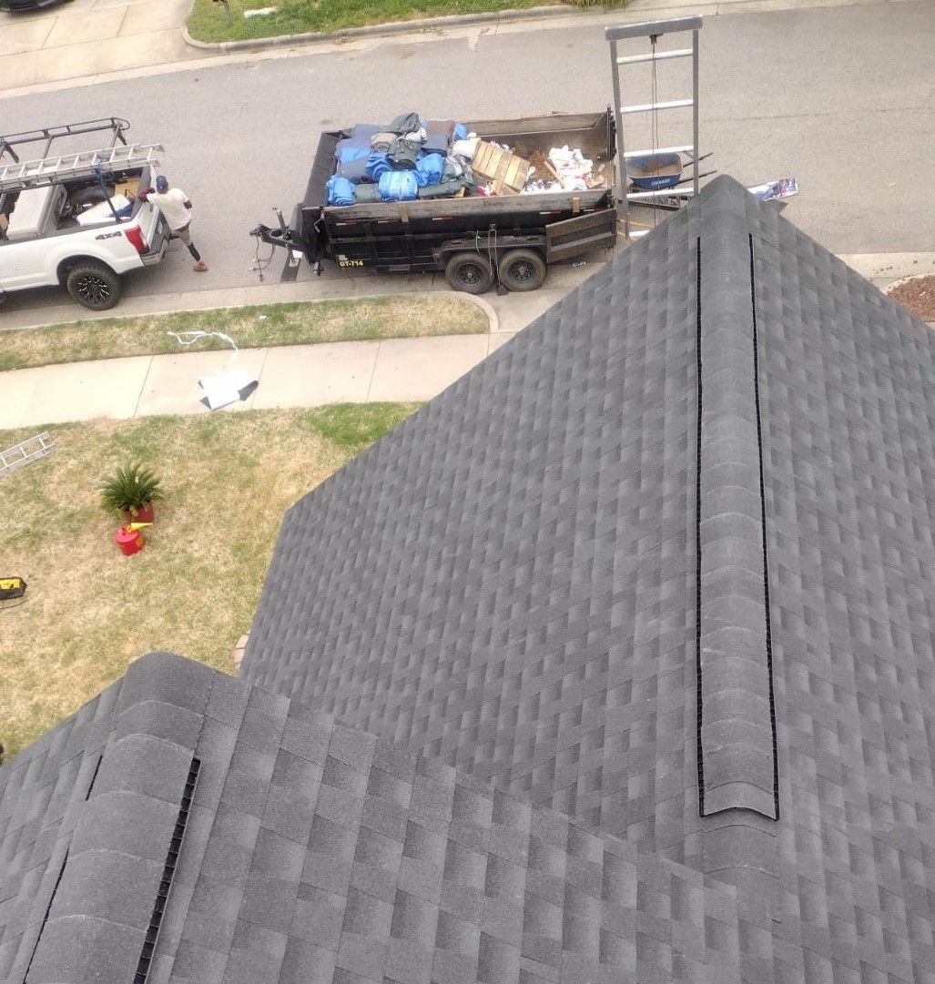 An aerial view of a roof with a dumpster on it