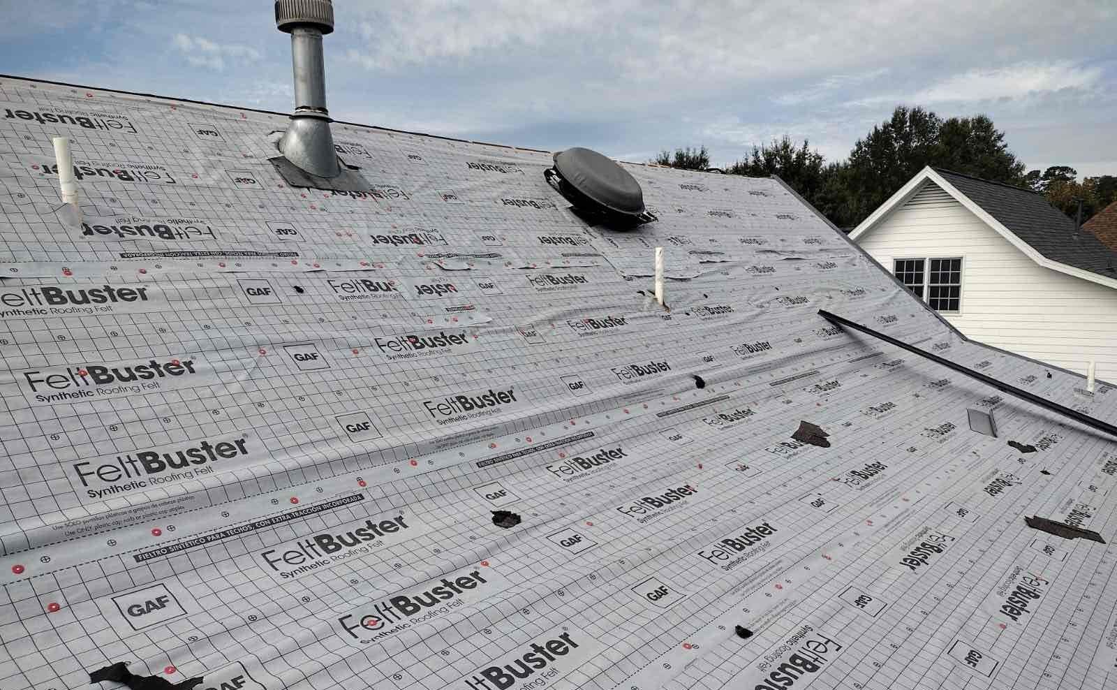 The roof of a house is covered in foil.