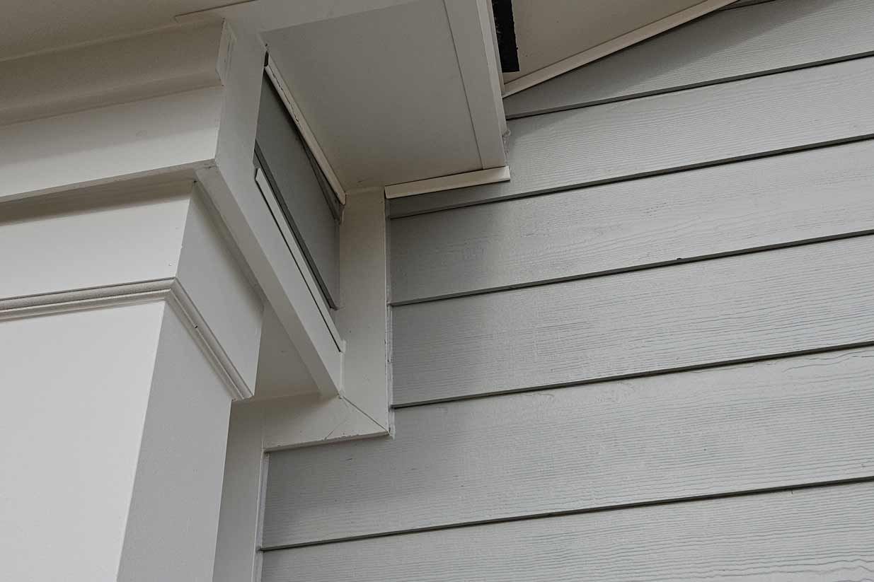 A close up of a house 's siding and roof