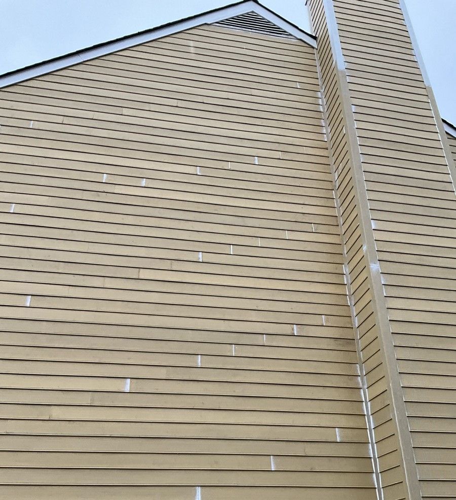 A house with a chimney on the side of it