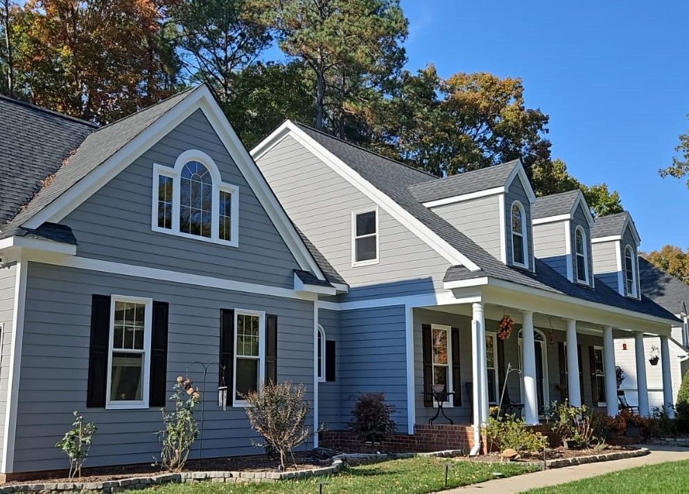 A large gray and white house with a large porch
