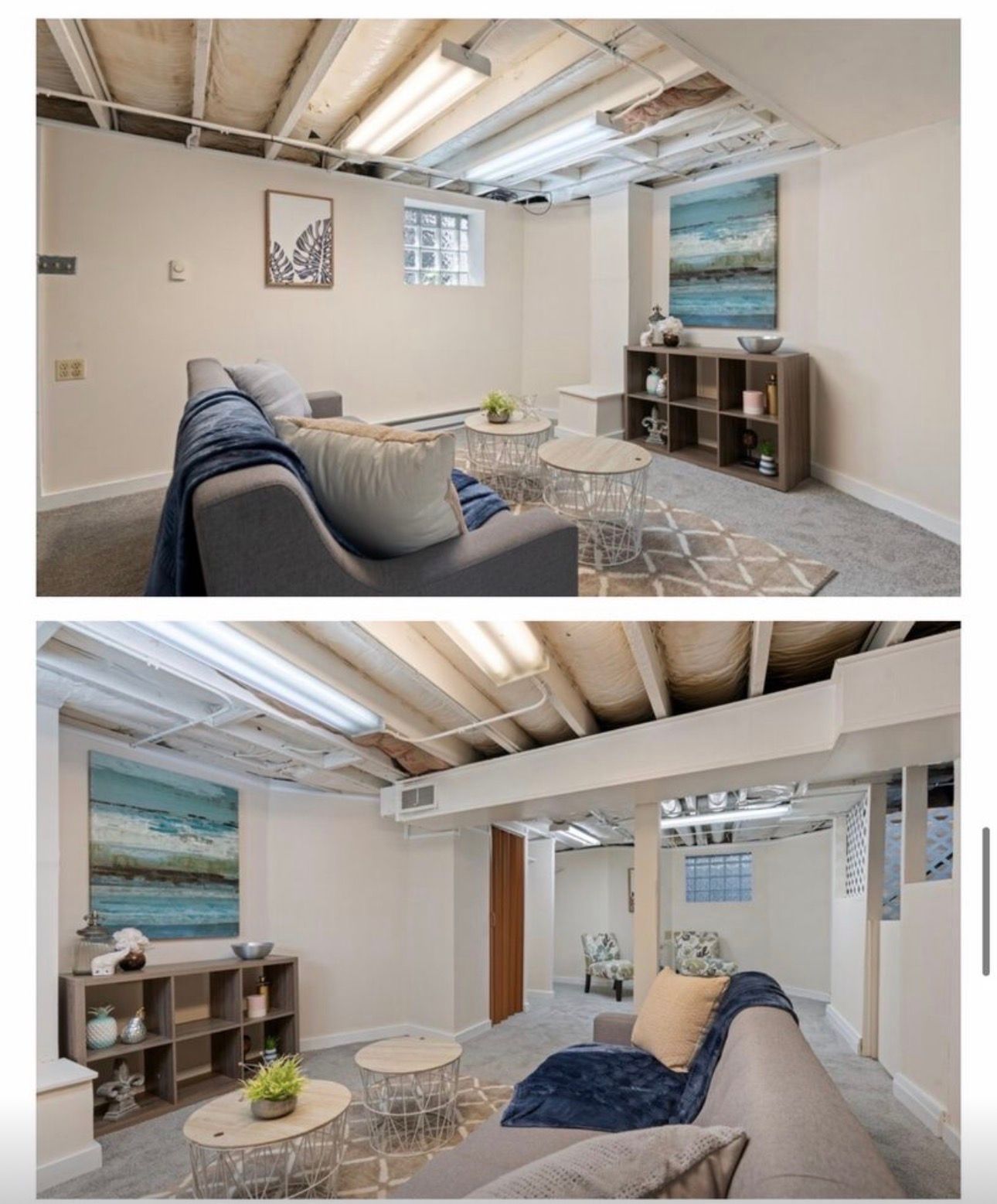 Bright living room with blue sofa, white coffee table, exposed beams, and ocean artwork on the wall.