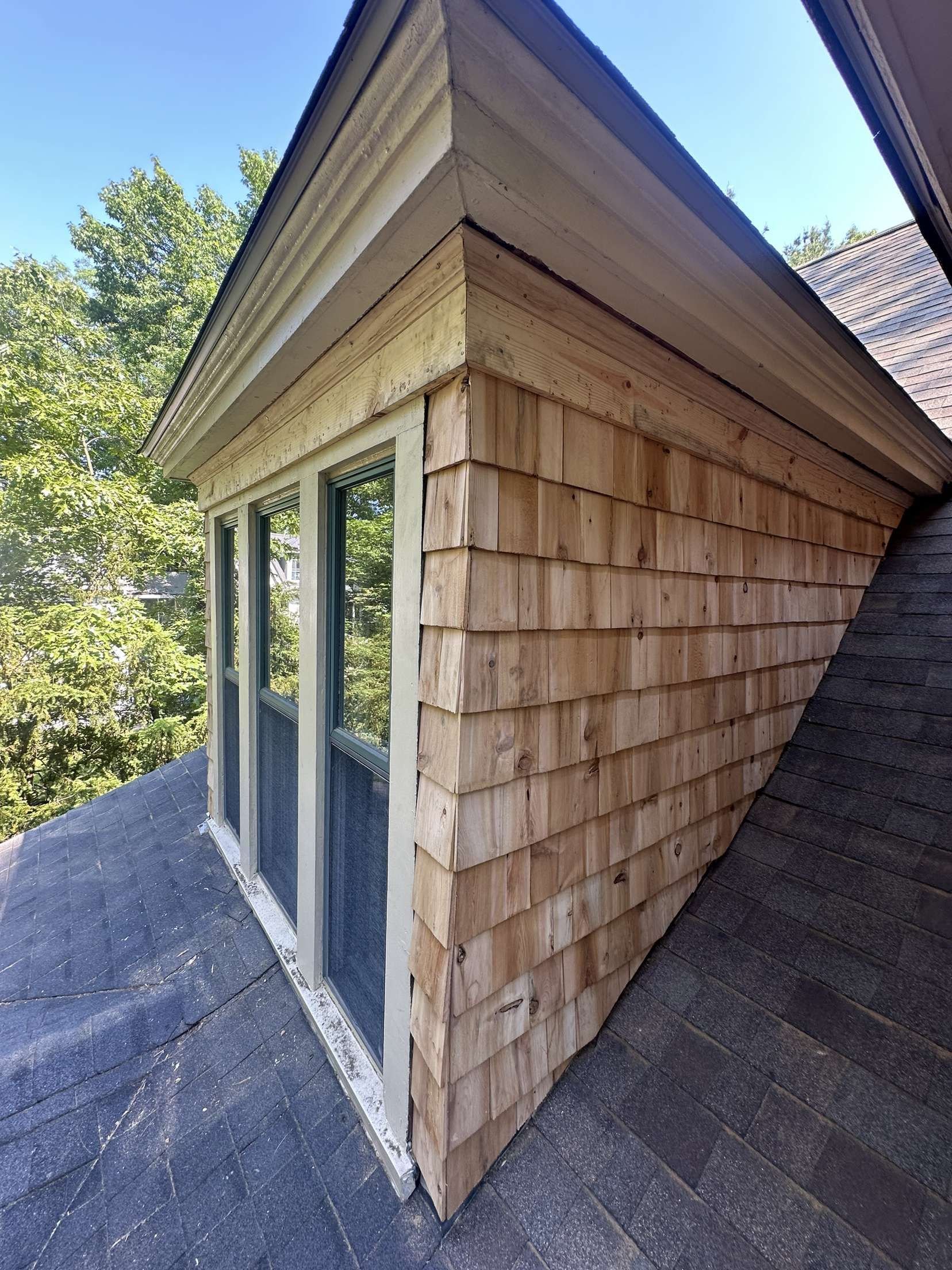 A house with a wooden roof and a window on the side.