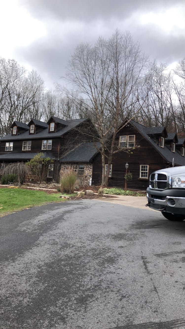 A truck is parked in front of a large house.