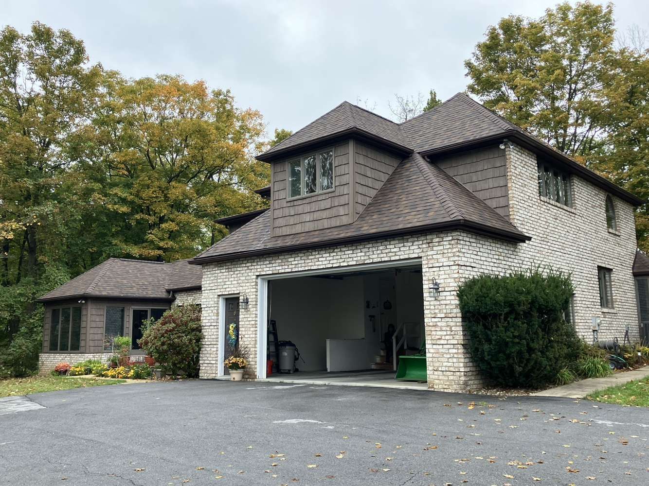 A large brick house with a large garage in front of it.
