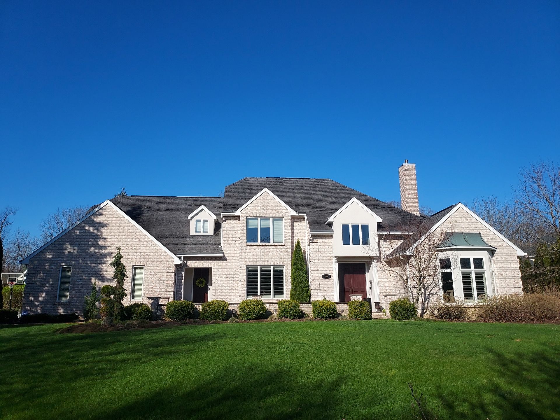 A large house with a lush green lawn in front of it.