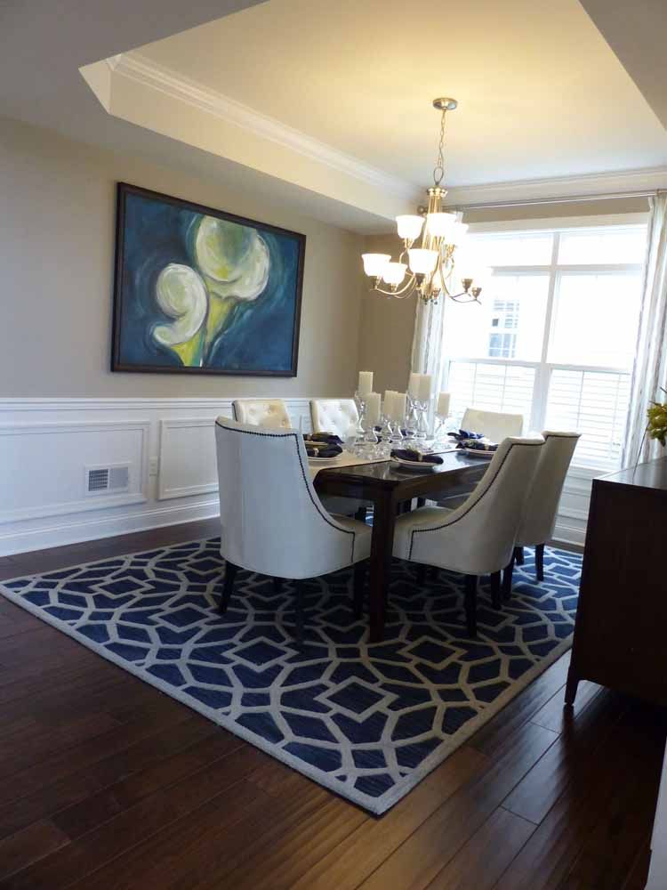 a dining room with a table and chairs and a rug
