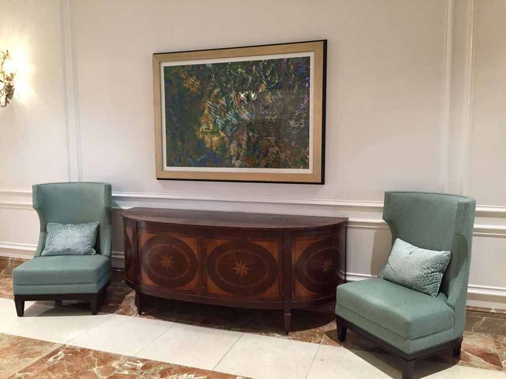 a room with two chairs and a painting on the wall
