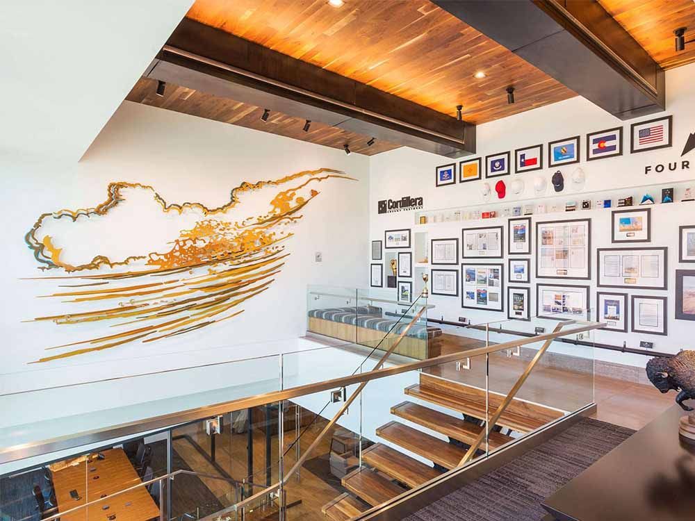 a room with stairs and a painting on the wall