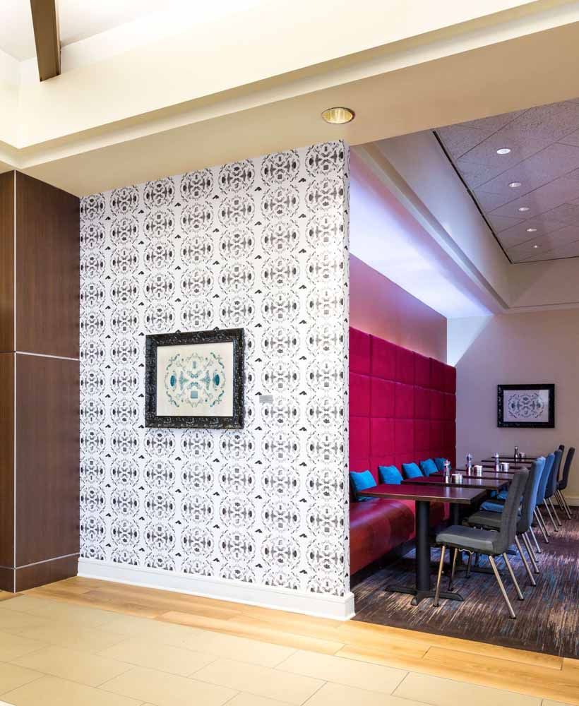 a room with tables and chairs and a picture on the wall