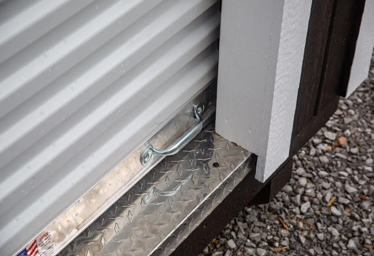 A close up of a garage door with a handle on it.