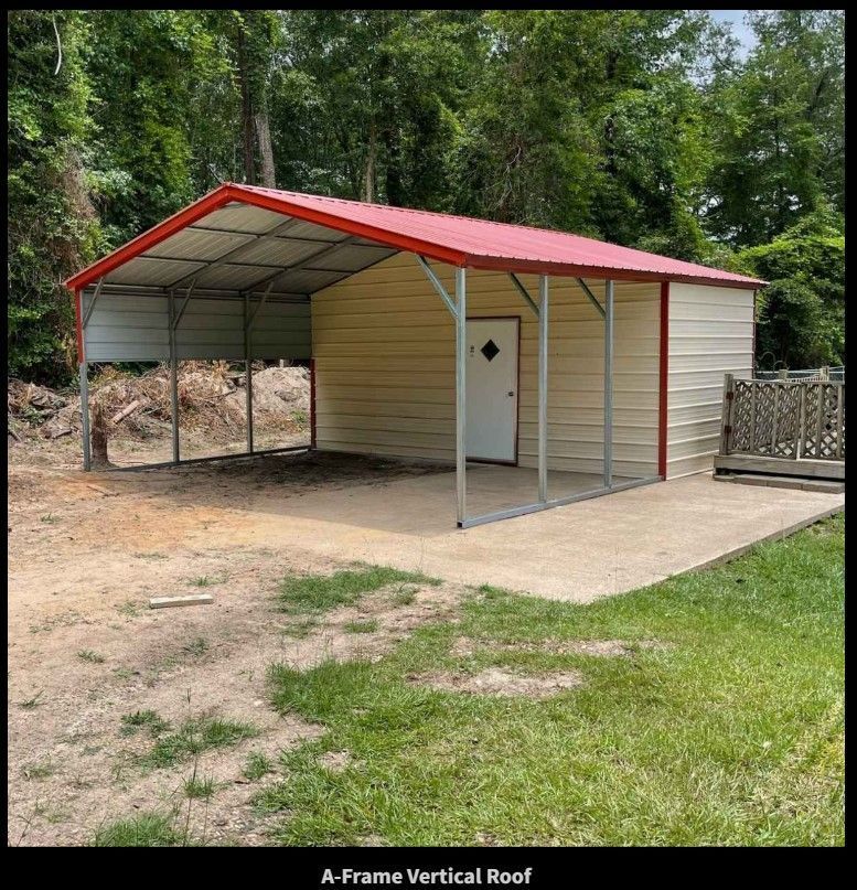 Tan and red metal shed with open carport, set on concrete pad with lawn and trees.
