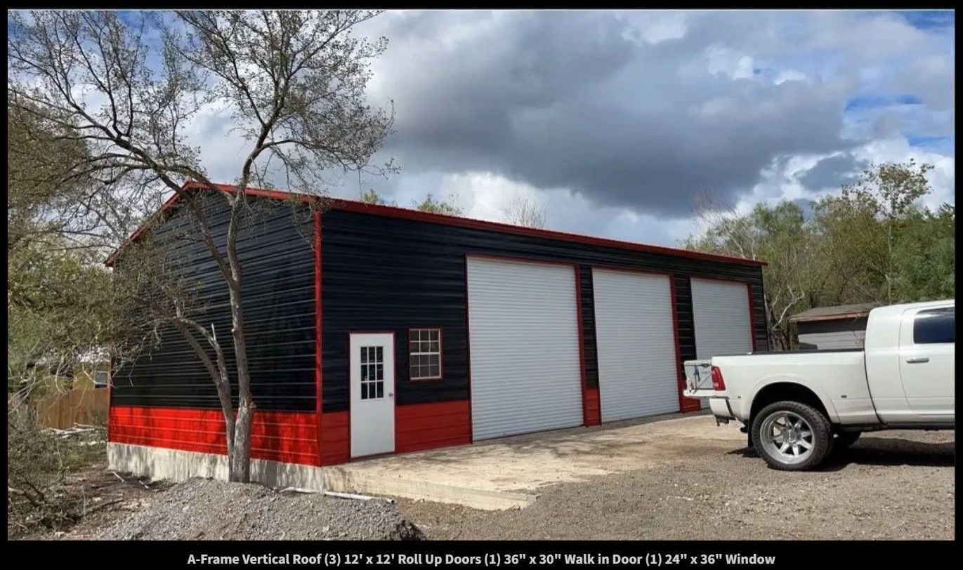 A white truck is parked in front of a black and red garage