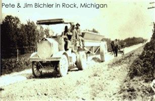 Pete & Jim Bichler on a truck in Rock, Michigan, working on a dirt road.