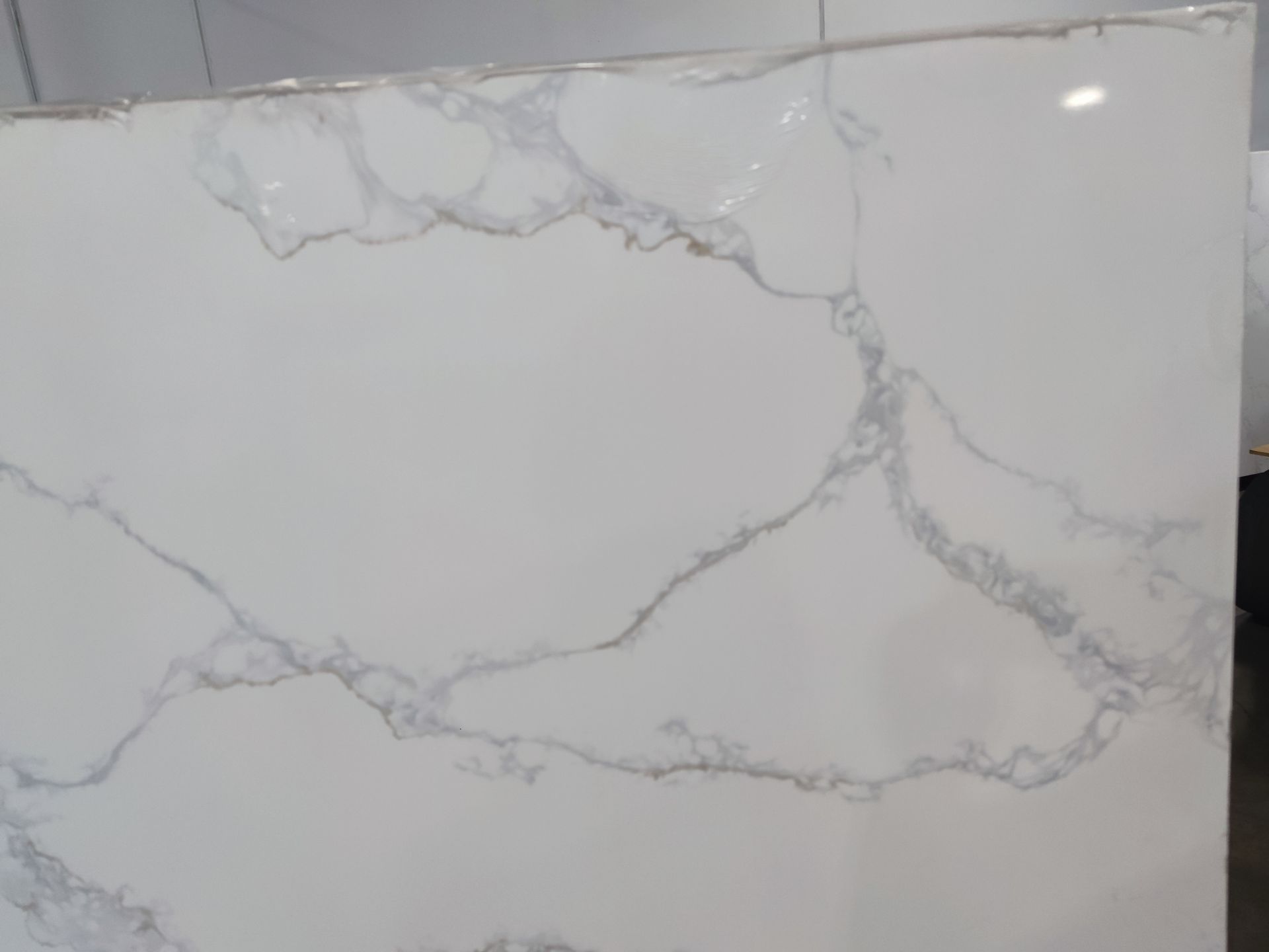 A close up of a white marble counter top in a kitchen.