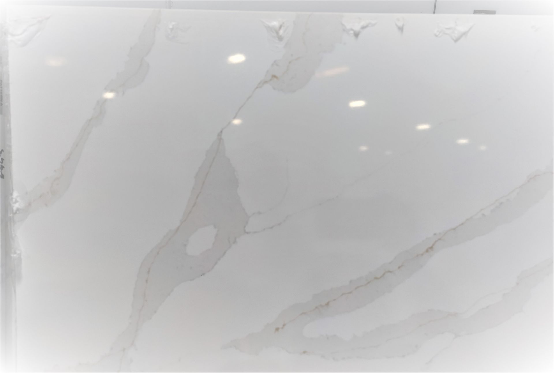 A close up of a white tile with a marble texture.