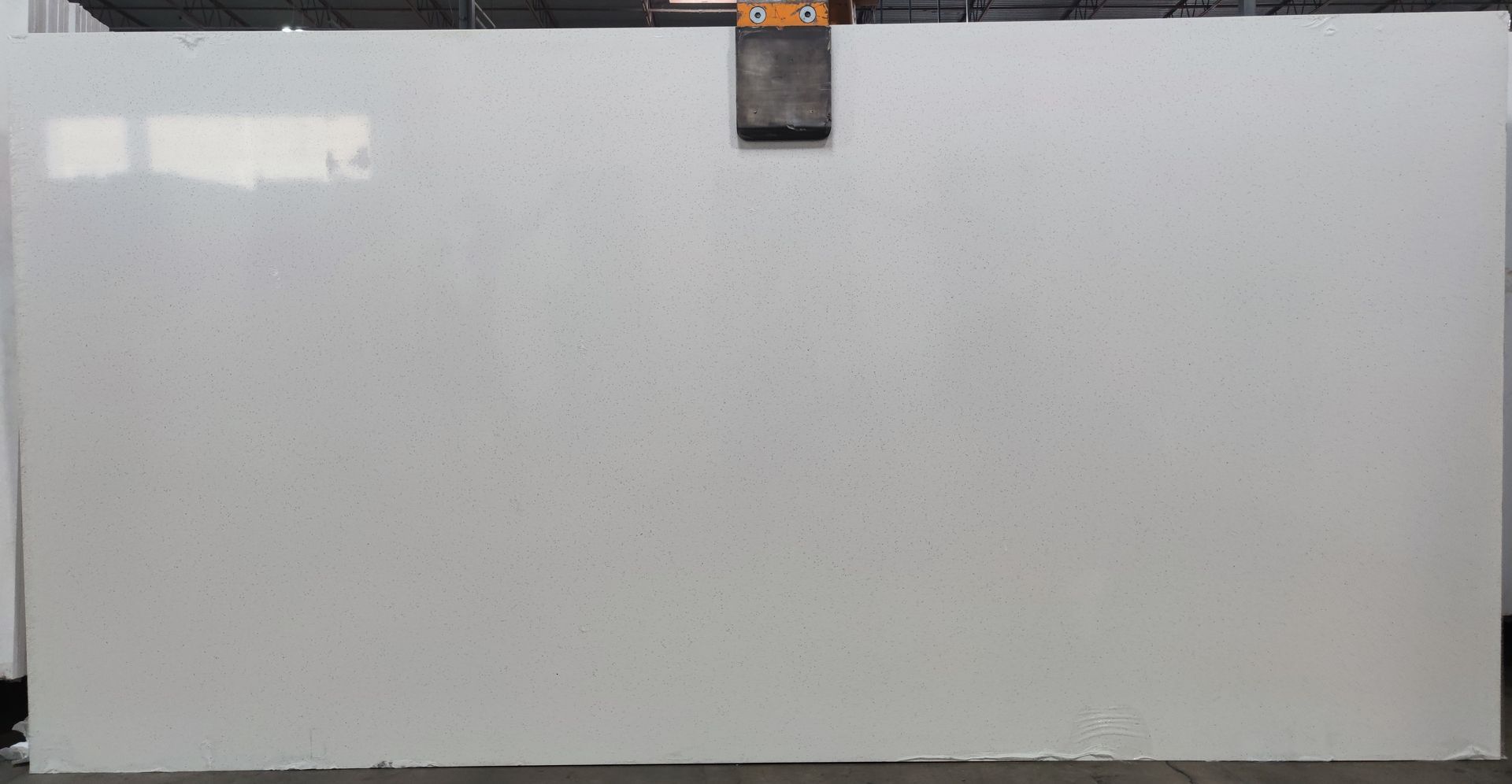 A large white slab of quartz is sitting on a table.