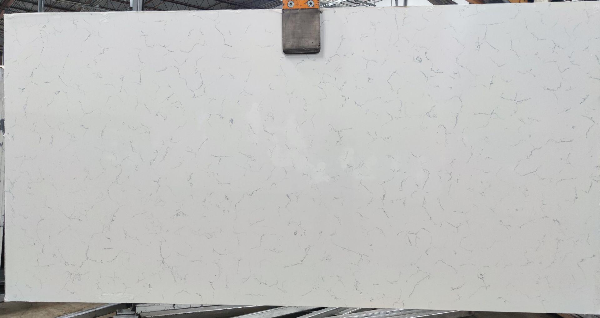 A white granite slab is sitting on top of a wooden table.