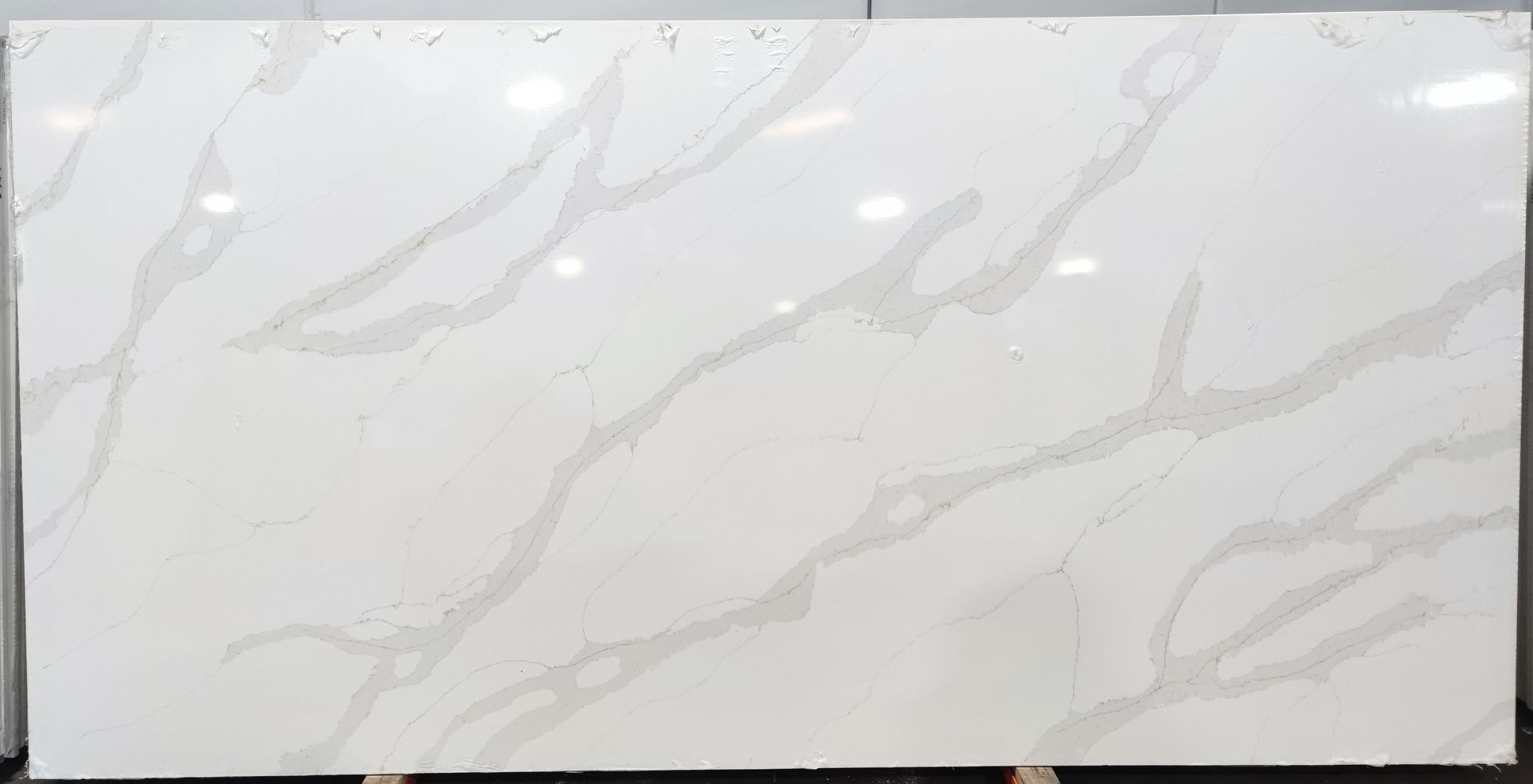 A large white marble slab is sitting on top of a wooden table.