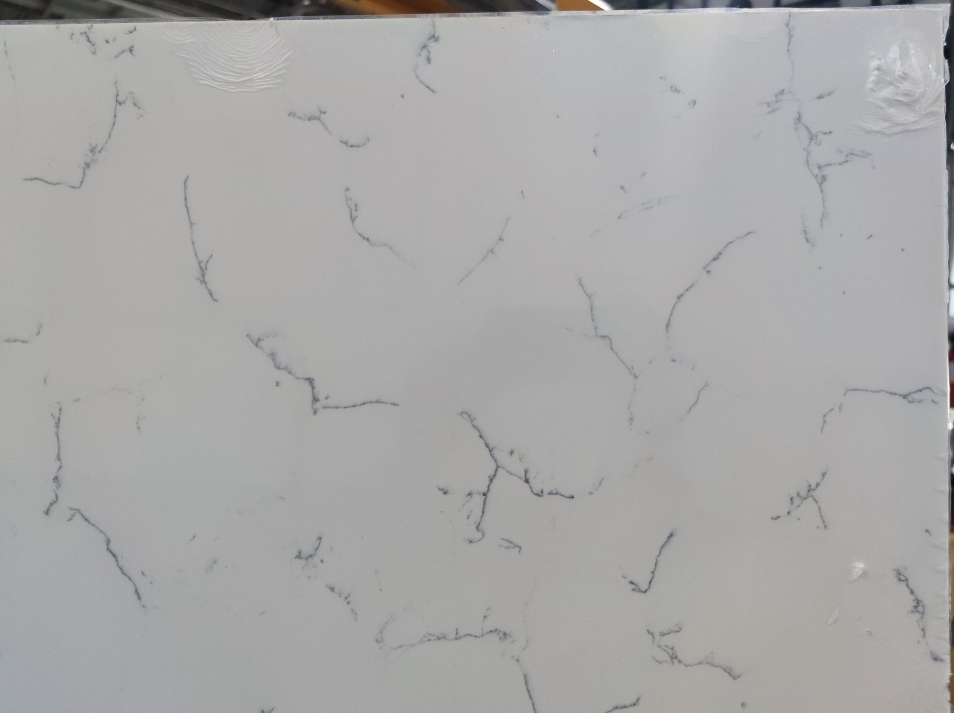 A close up of a white marble counter top.