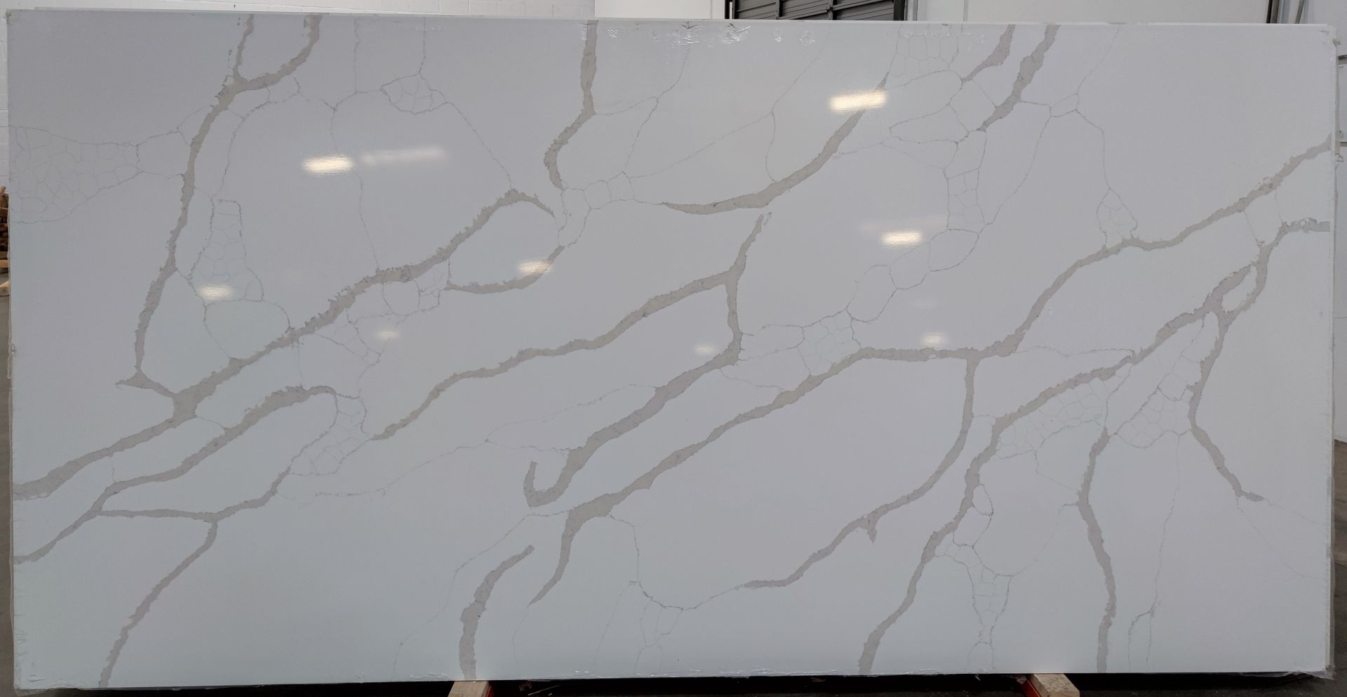 A large white marble slab is sitting on top of a wooden table.