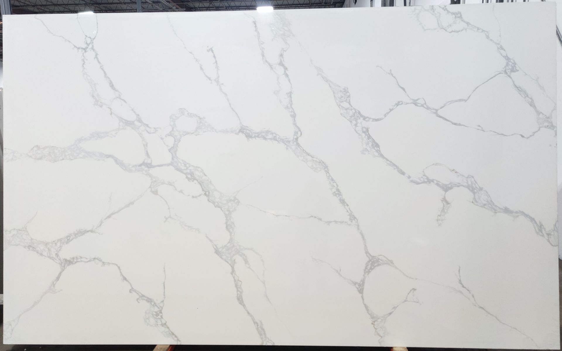 A white marble slab is sitting on top of a wooden table.