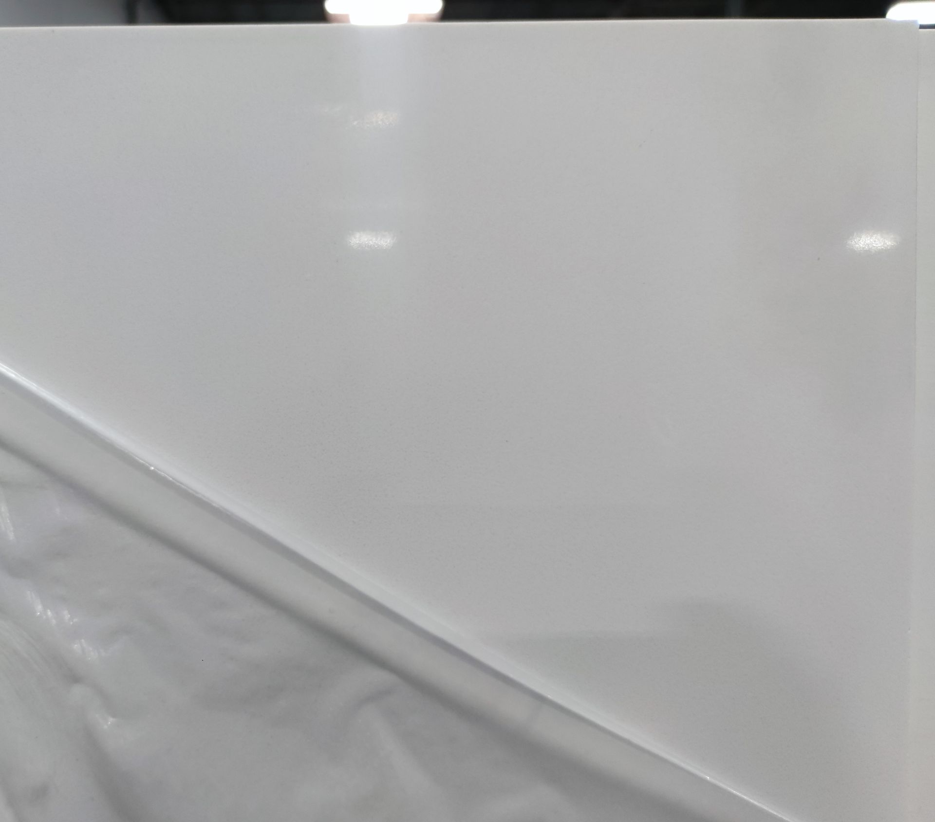 A close up of a piece of white plastic on a table.