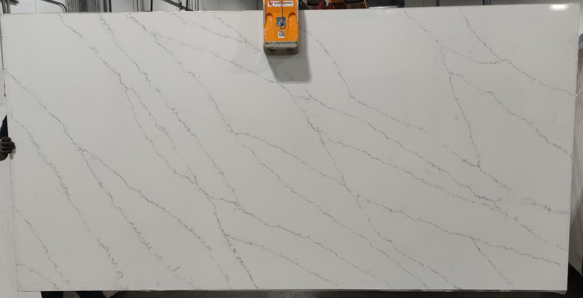 A large white marble slab is sitting on top of a wooden table.