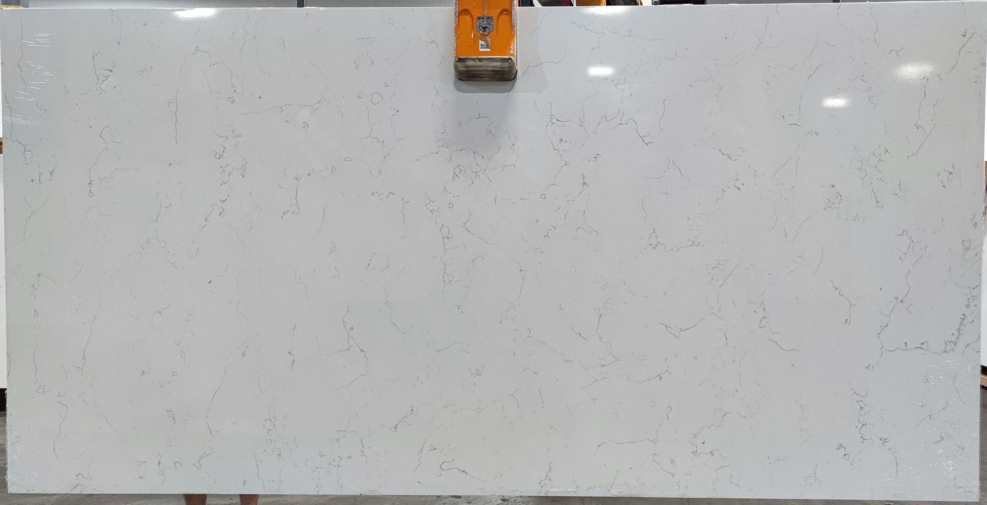 A large white marble slab is sitting on top of a wooden table.