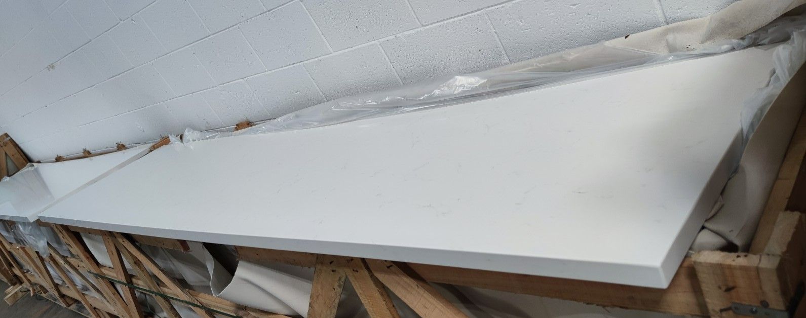 A white piece of wood is sitting on top of a wooden table.