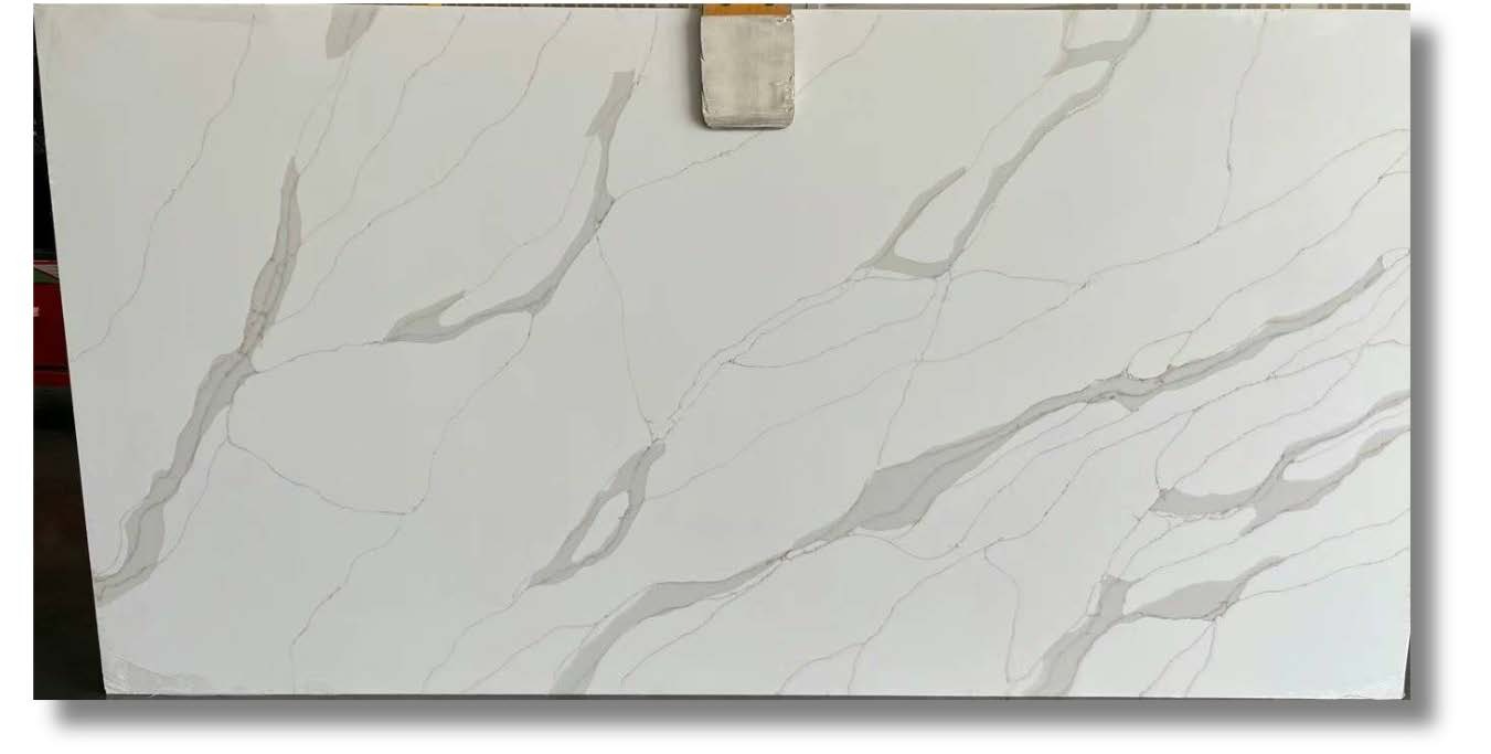 A white granite slab with a marble texture is sitting on a table.