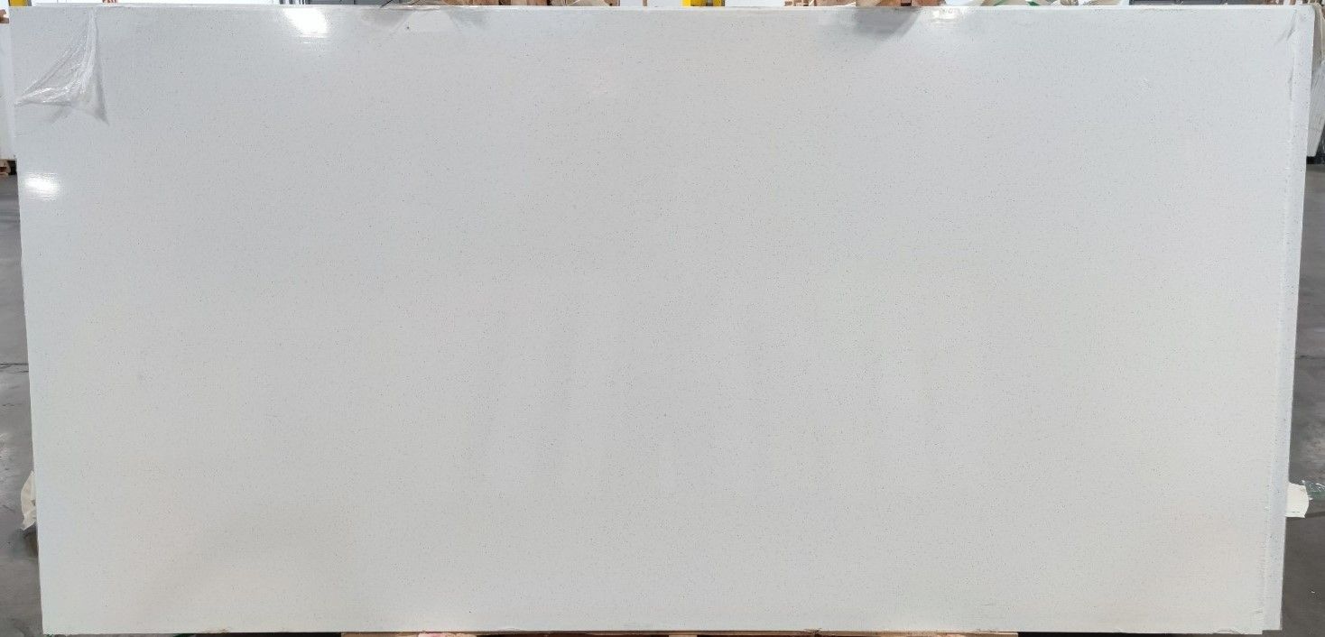 A large white slab of quartz is sitting on top of a wooden table.