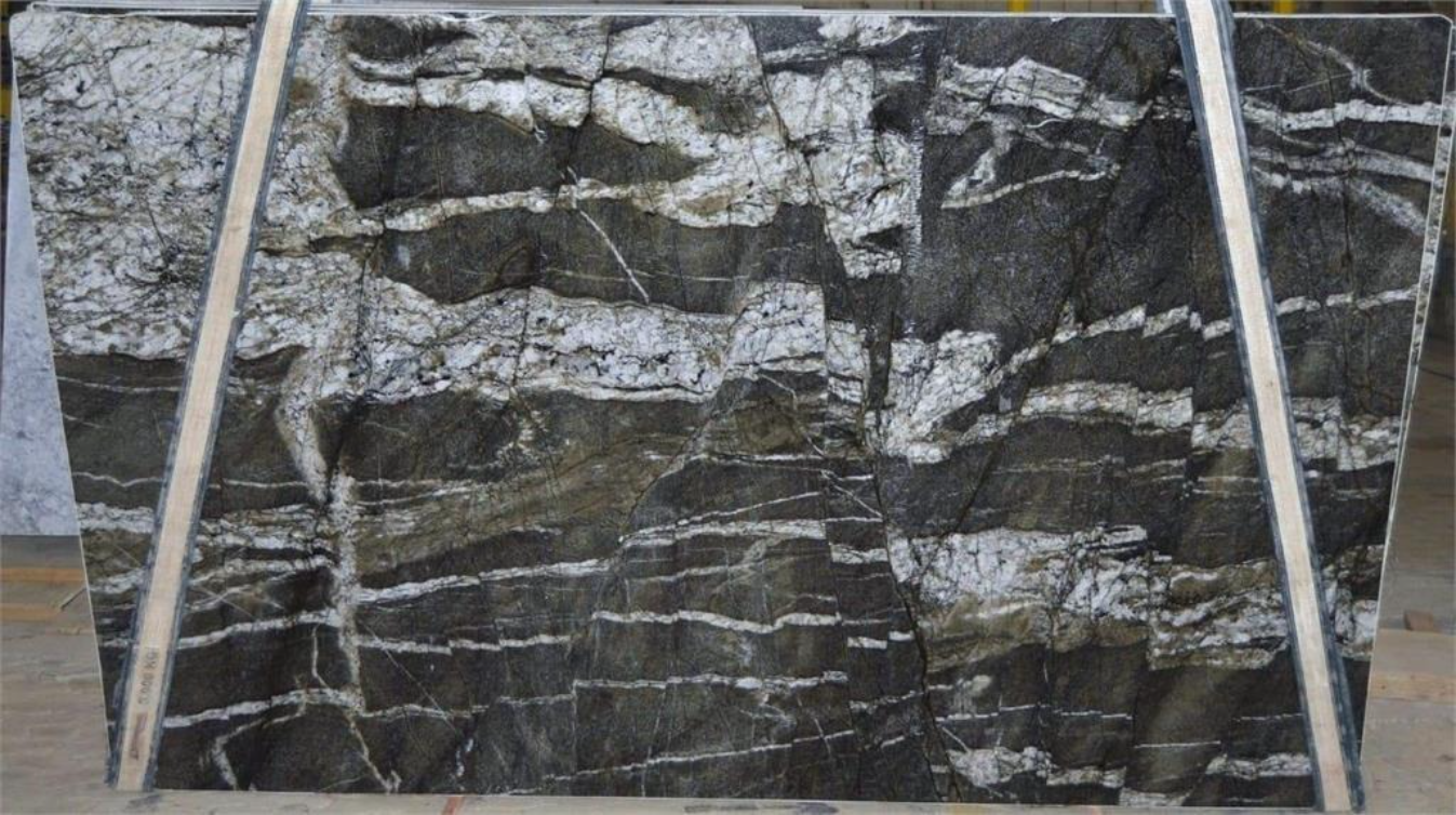 A black and white granite slab is sitting on top of a wooden table.