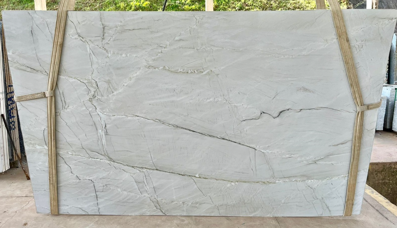 A large white marble slab is sitting on top of a wooden table.