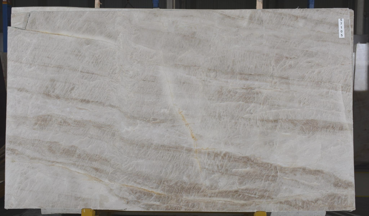 A large white marble slab is sitting on top of a glass shelf.