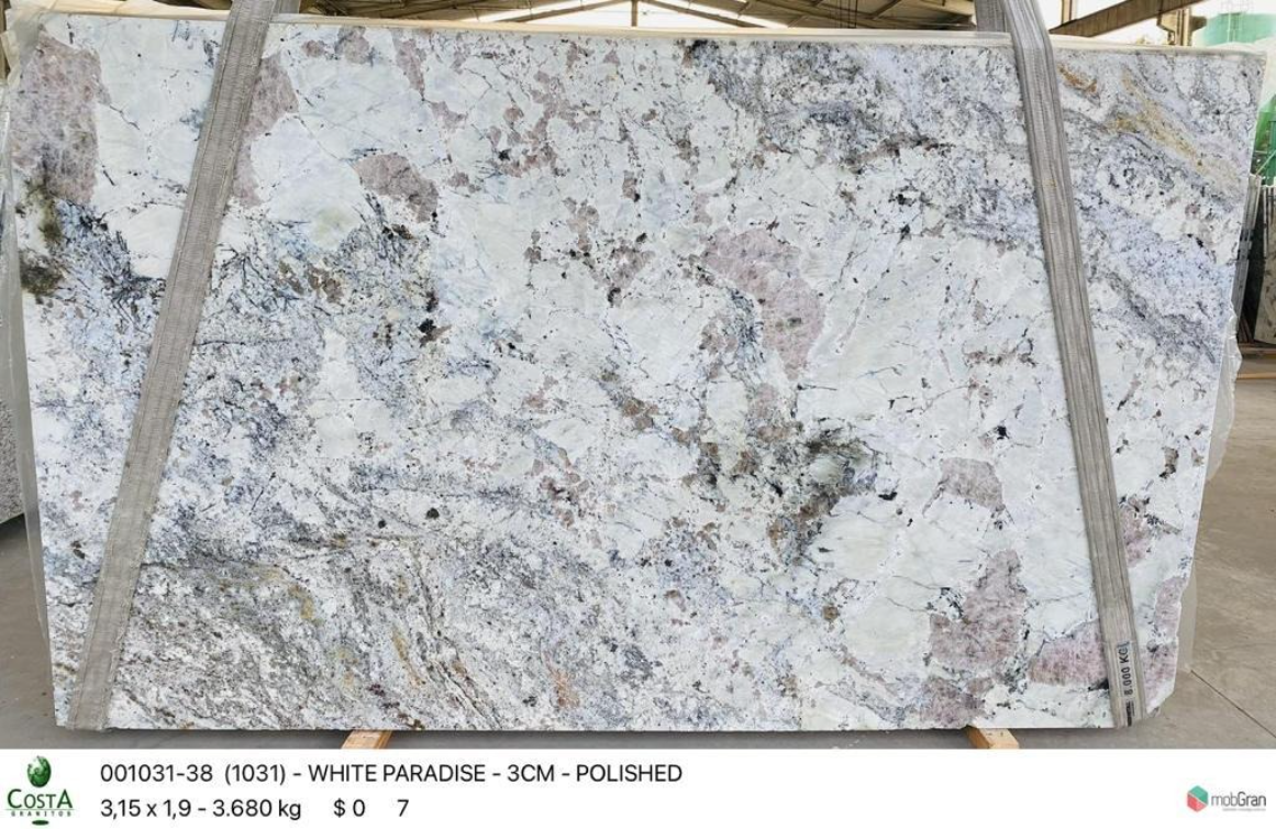 A white granite slab is being displayed in a store.