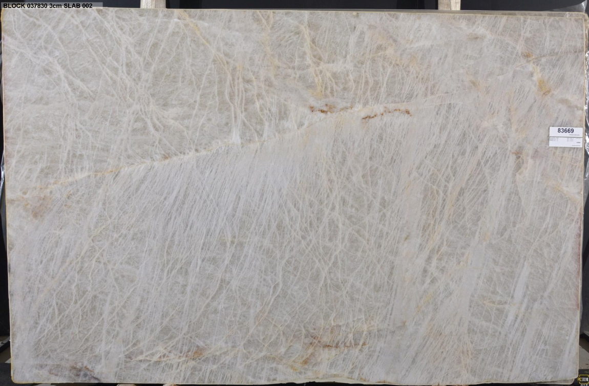 A large white marble slab is sitting on a wooden shelf.