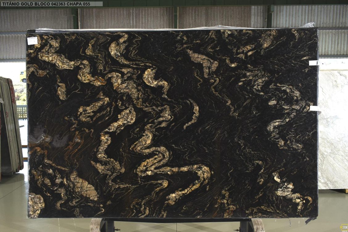A black and gold marble slab is sitting on a stand.
