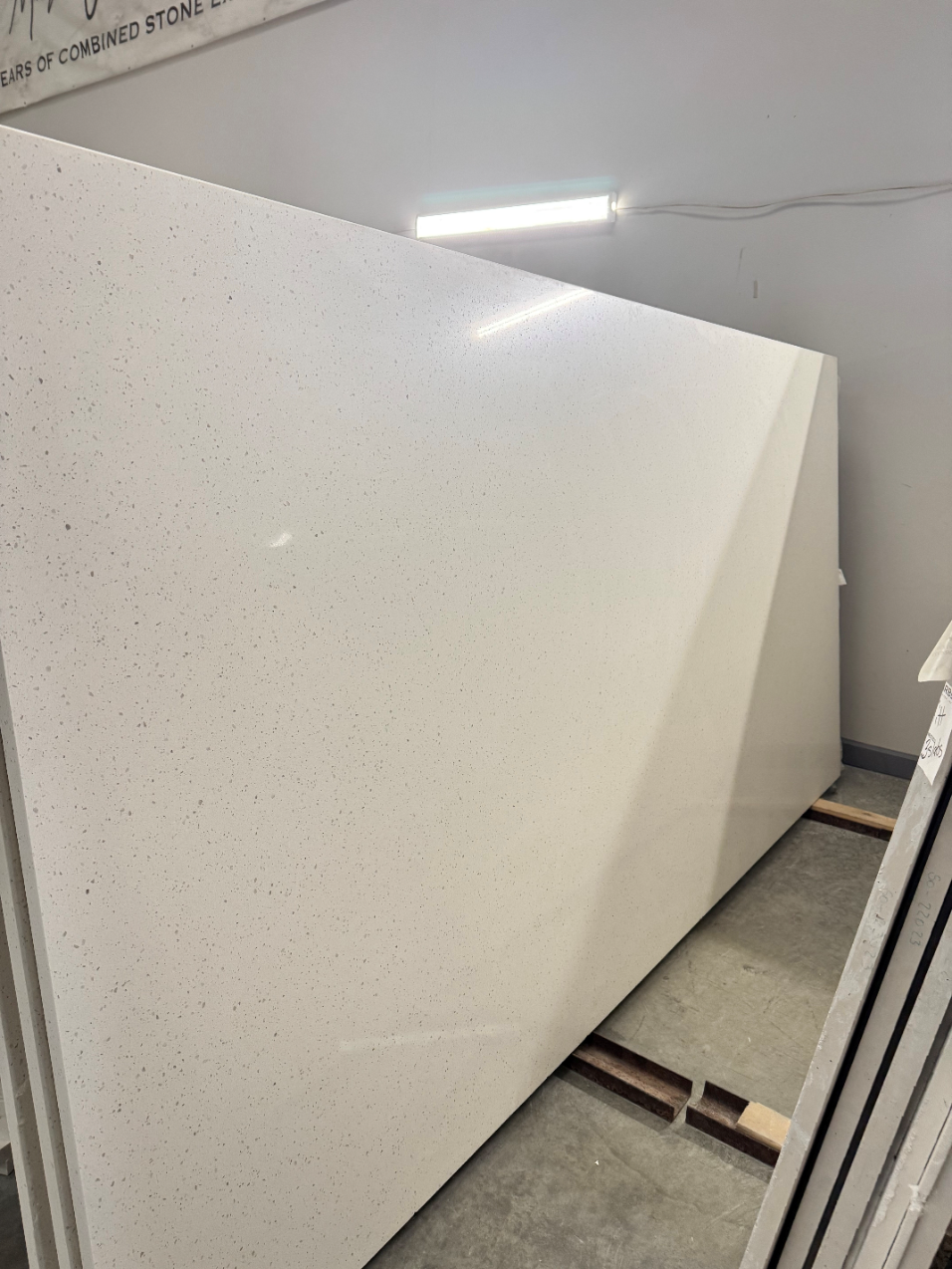 A large white granite slab is sitting on top of a wooden pallet.