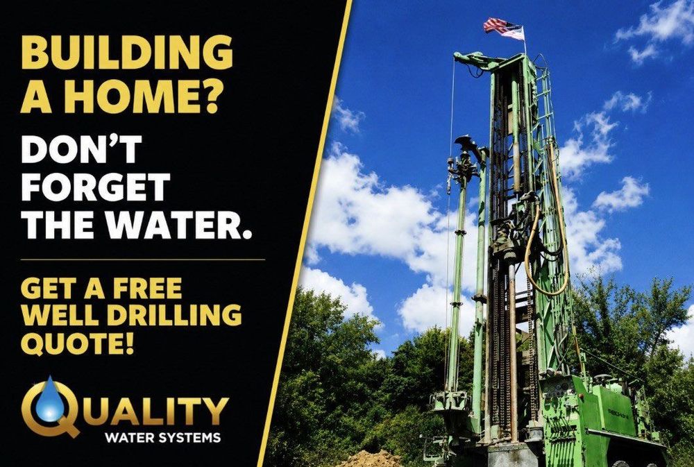 Billboard for free well drilling quote beside a tall drilling rig under a blue sky