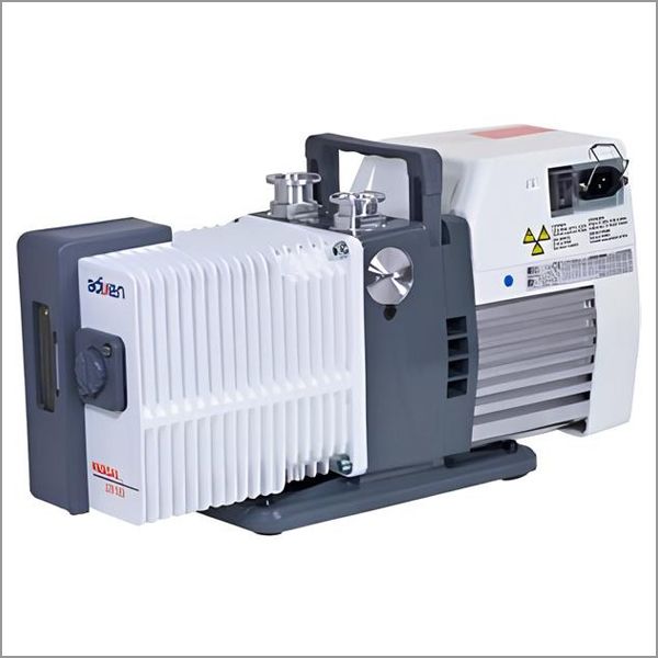 Vacuum pump, Adixen brand, gray and white, with ribbed sides and handle, electrical connections.