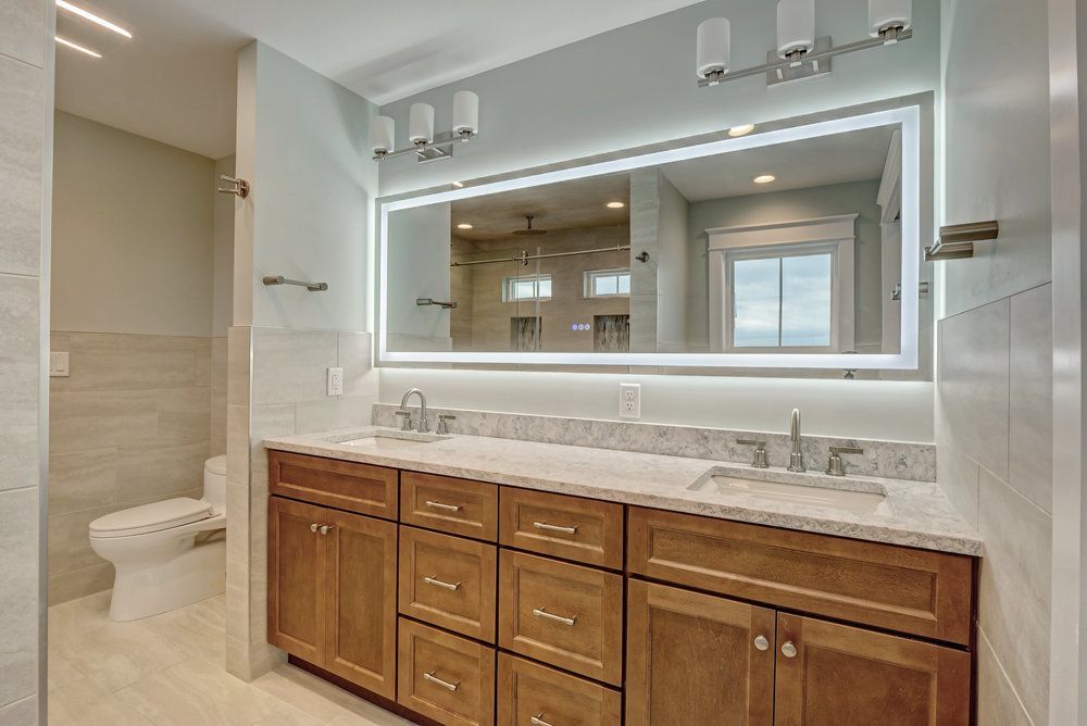 A bathroom with two sinks and a large mirror.