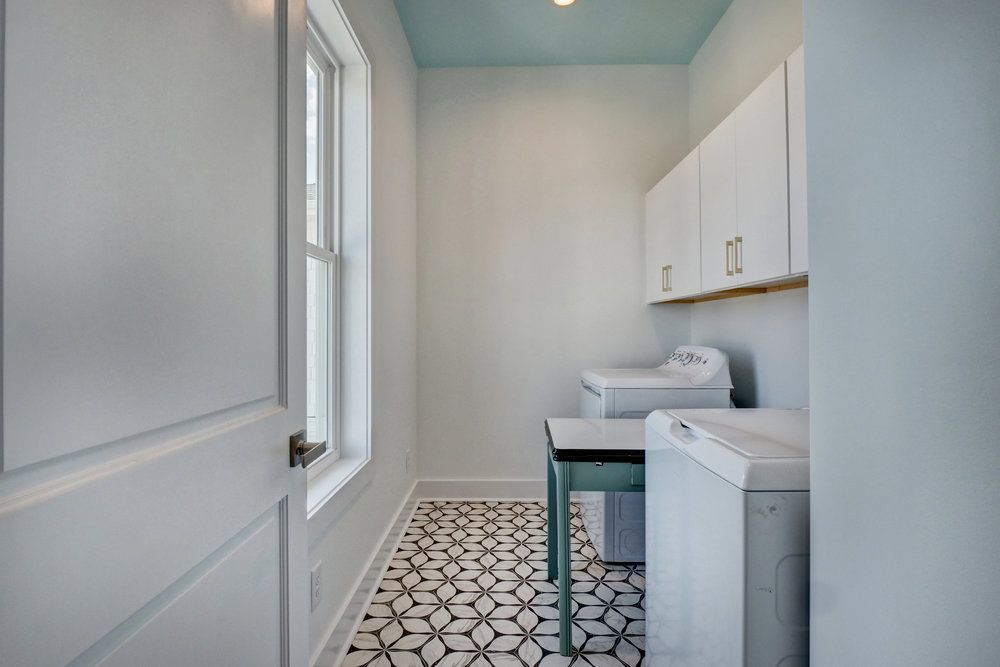 A laundry room with a washer and dryer and a window.
