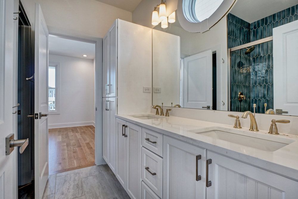 A bathroom with two sinks and a large mirror.
