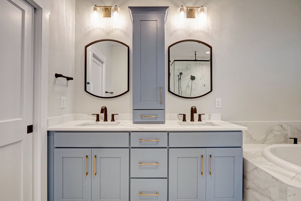 A bathroom with two sinks and two mirrors.