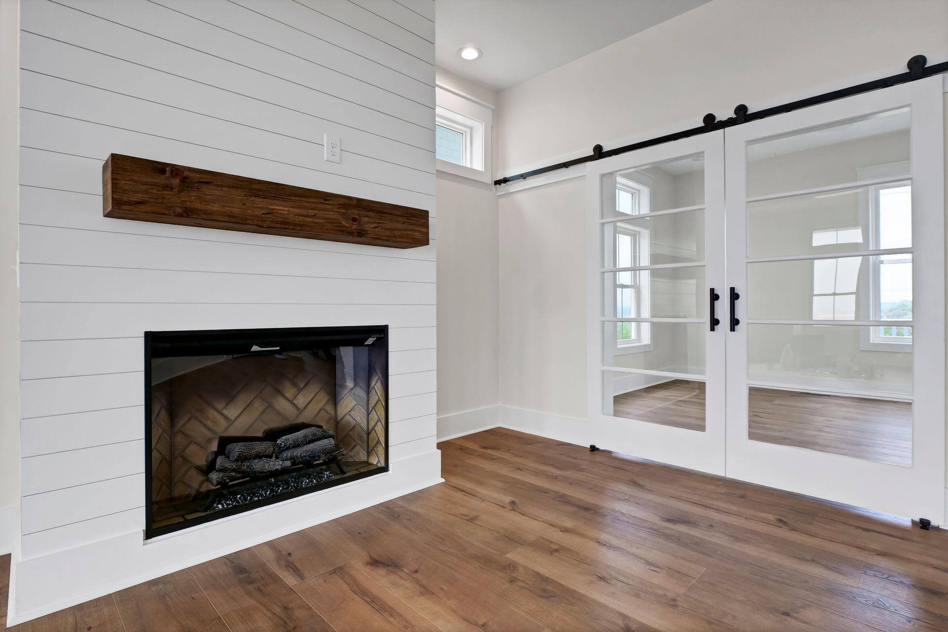 A living room with a fireplace and sliding glass doors.