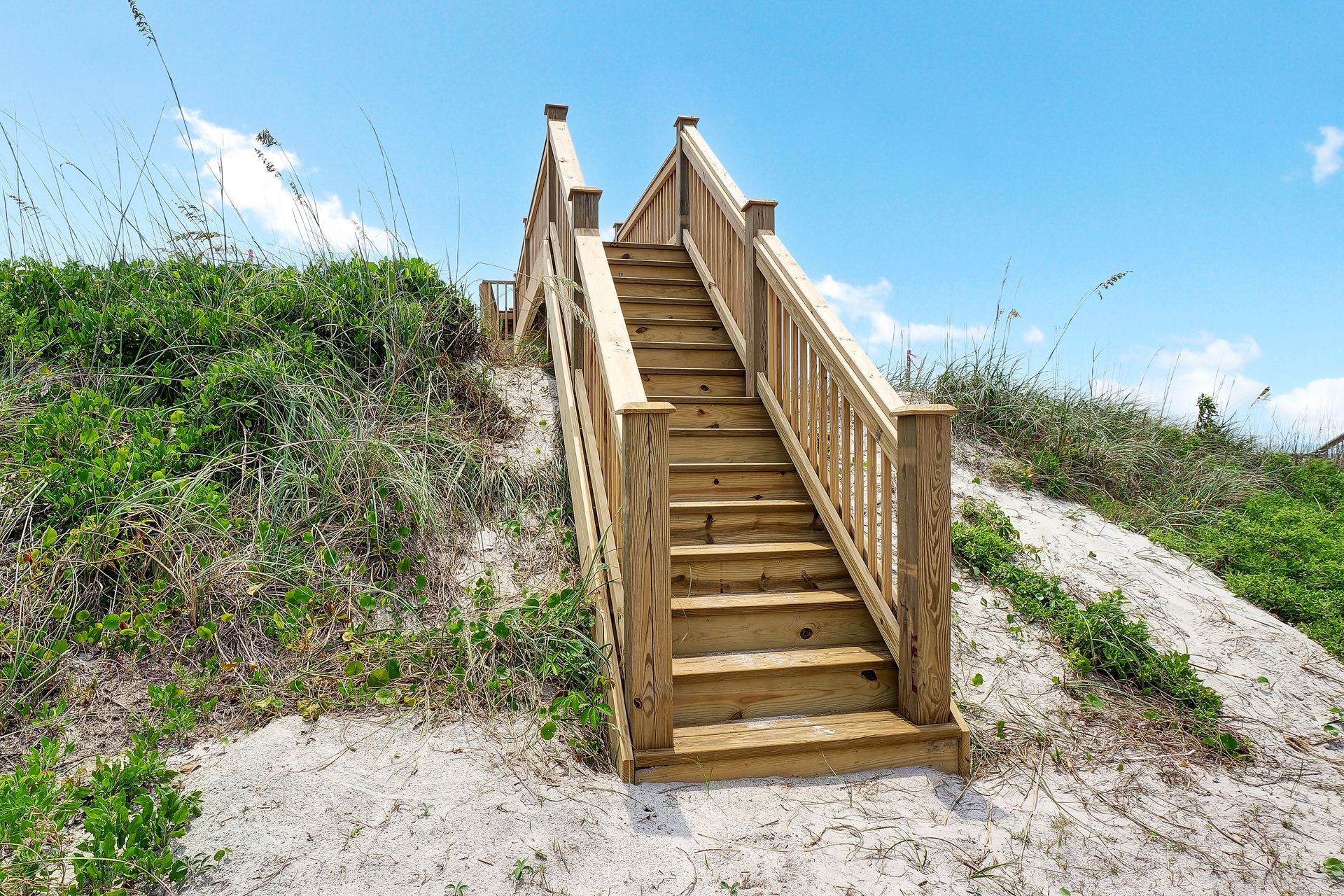 A wooden staircase leading up to the beach.