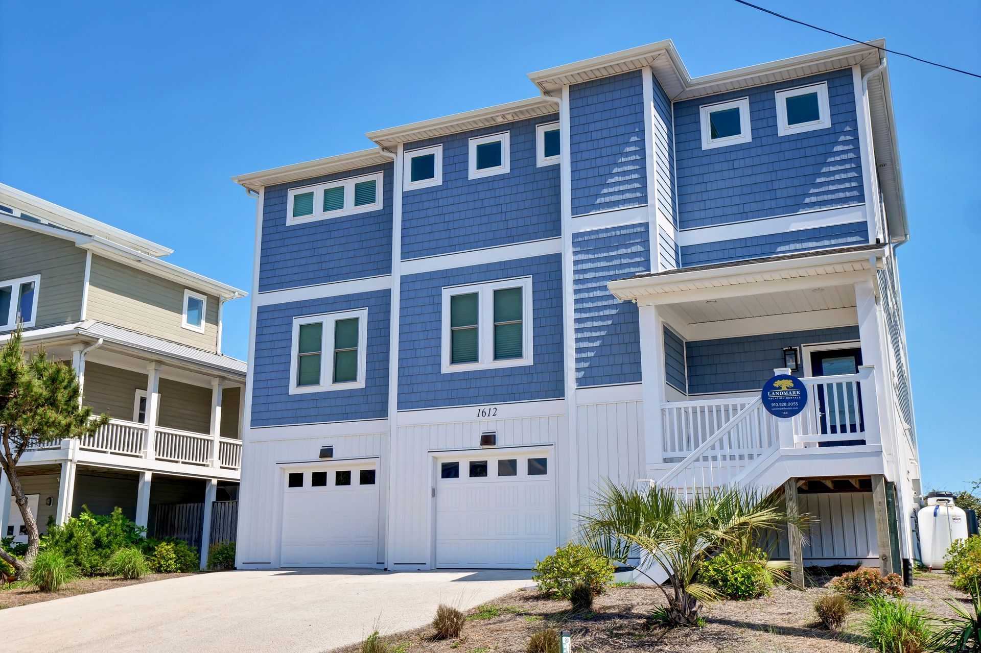 A large blue and white house with a lot of windows