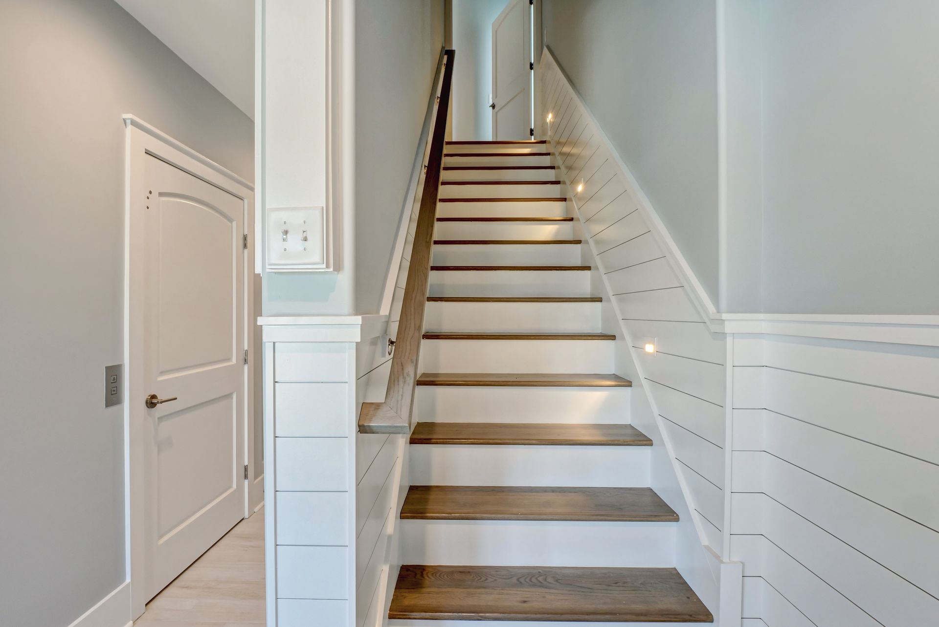 A set of stairs leading up to the second floor of a house.