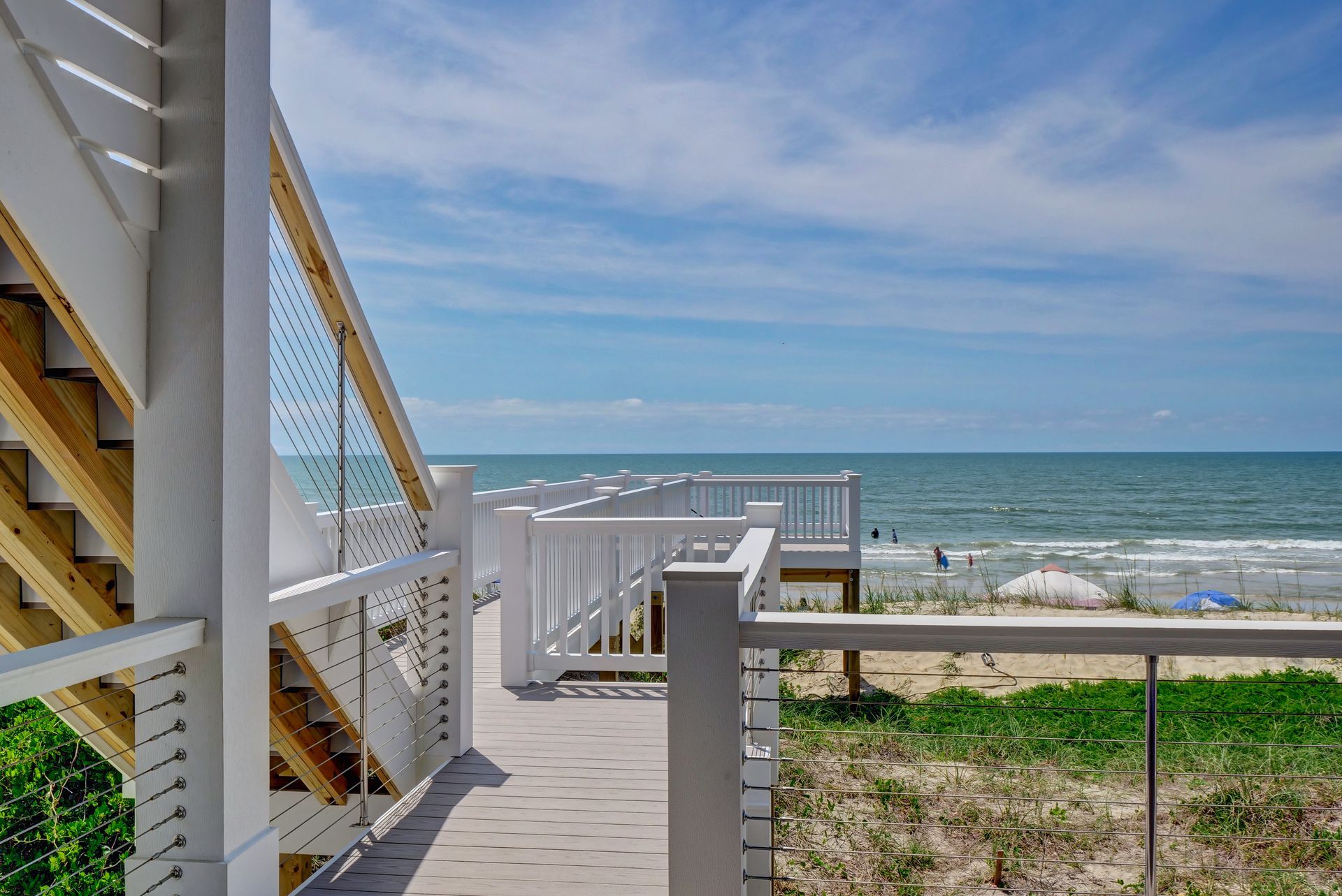 A walkway leading to a beach with a view of the ocean.